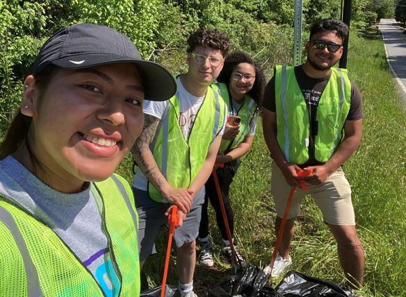 Students picking up trash from the side of the road / 